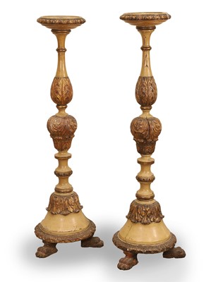 Lot 512 - A pair of carved cream painted torchere