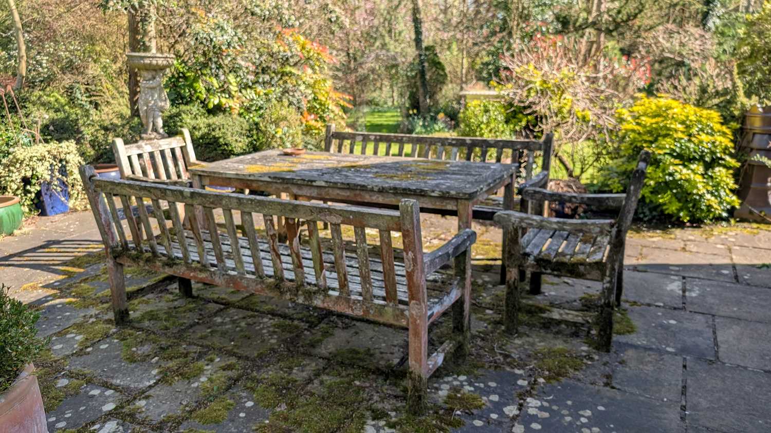 Lot 556 - A teak garden furniture set
