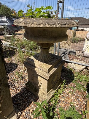 Lot 552 - A blush terracotta urn on plinth