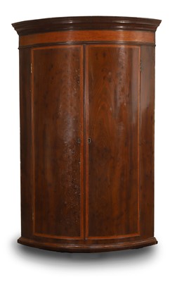 Lot 528 - A George III mahogany ‘plum pudding’ and satinwood crossbanded corner cupboard