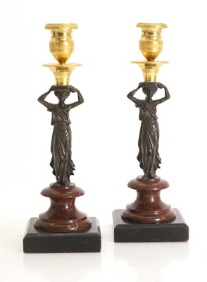 Lot 347 - A pair of bronze and ormolu candlesticks