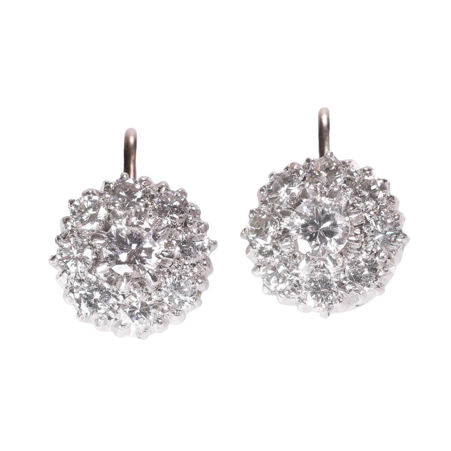Lot 126 - A pair of diamond daisy cluster earrings
