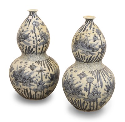 Lot 61 - A pair of blue and white porcelain double gourd vases