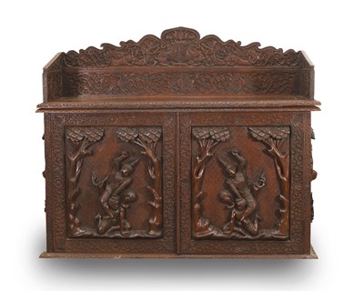 Lot 528 - A carved hardwood cabinet