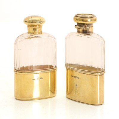 Lot 43 - A near pair of silver and clear glass hip flasks
