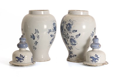 Lot 124 - A pair of Dutch Delft blue and white baluster vases and covers
