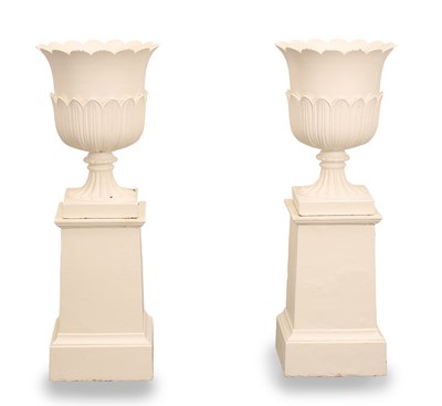 Lot 552 - A pair of cast iron painted urns and stands