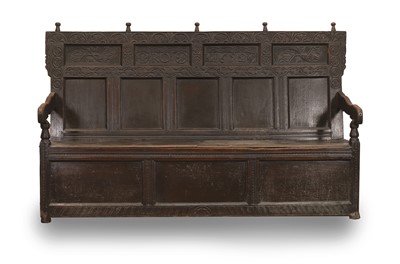 Lot 526 - A carved oak settle
